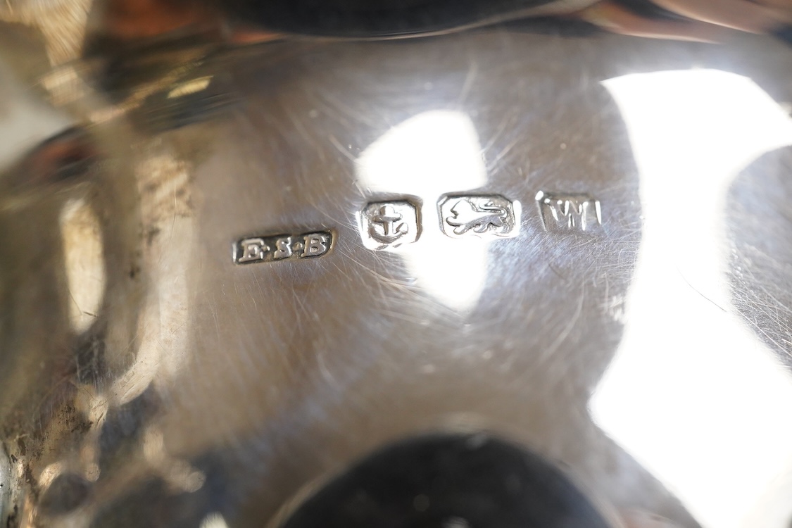 A pair of George V silver sauceboats, with scroll handles, on three hoof feet, E S Barnsley & Co, Birmingham, 1921, length approx. 17.3cm, 10.2oz.